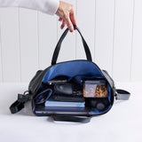 Rome leather tote in black showing items packed inside.