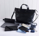 Rome leather tote with items in front to show what fits inside.